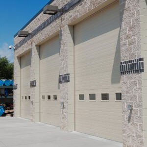 A set of three large garage doors outside of a property